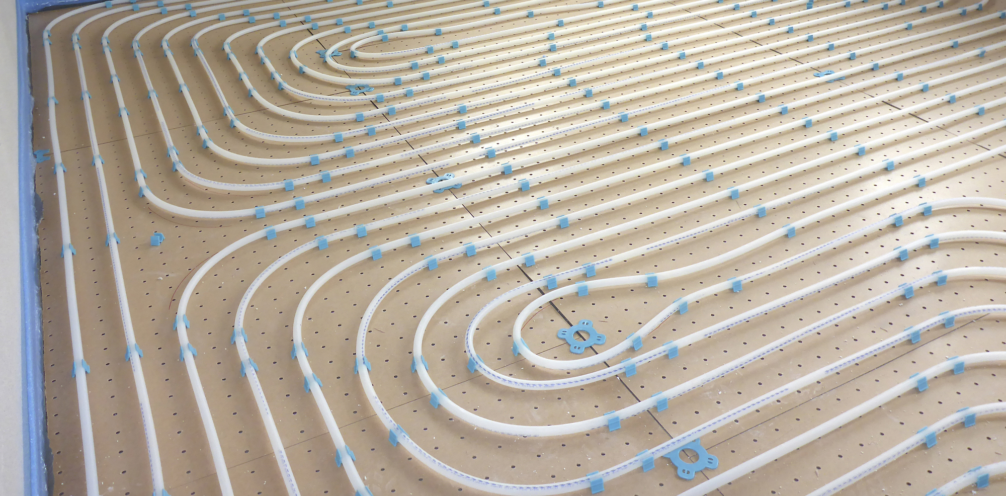Wet underfloor heating system in a newly constructed house, shown before floor is laid on top.